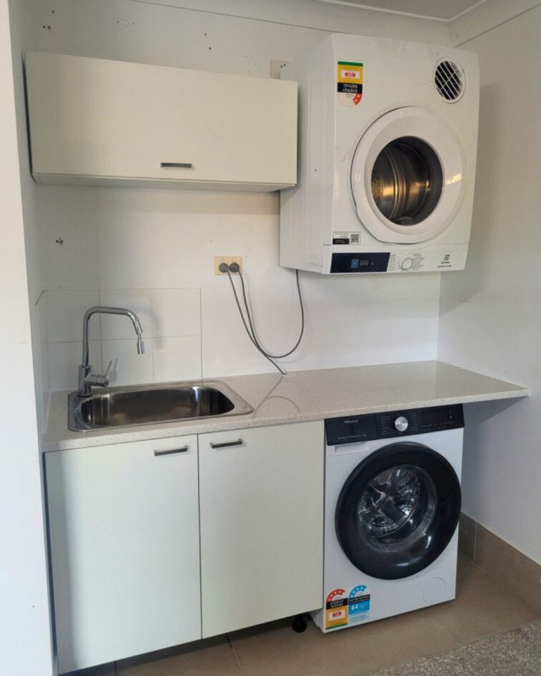 Laundry after new cabinetry and benchtop installation